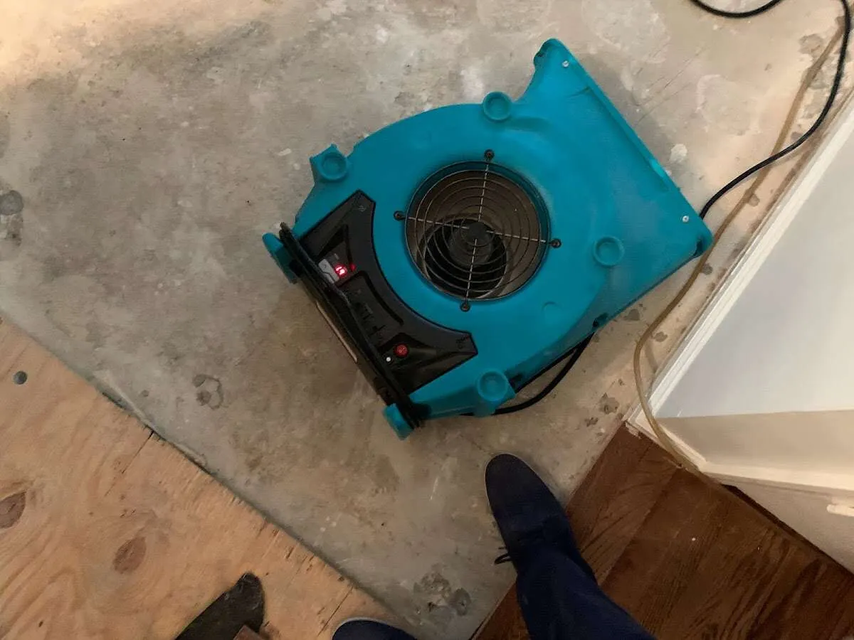 Air mover drying subfloor during Commercial Water Damage Restoration in Vandalia